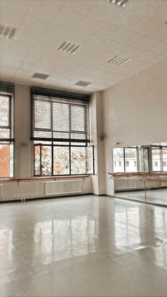 an empty room with large windows and no people in the room or on the floor