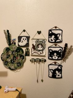 there are many crocheted pictures hanging on the wall