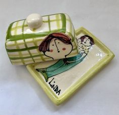 two ceramic dishes with designs on them sitting on a table