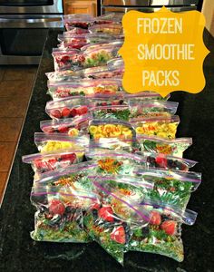 frozen smoothie packs lined up on a kitchen counter with the words frozen smoothie packs