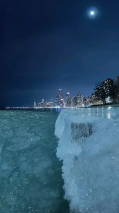 the water is crystal blue and there are buildings in the backgroung area