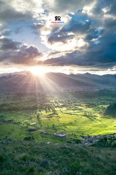 the sun shines brightly over a green valley