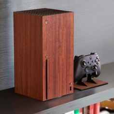 a video game controller sitting on top of a shelf