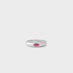 a white gold ring with a pink stone