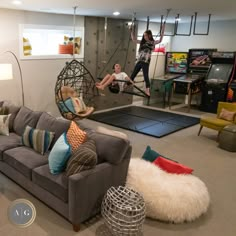 two women are in the living room playing with hammocks and other items on the floor