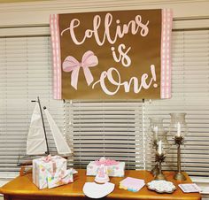 a wooden table topped with lots of boxes next to a sign that says collins is one