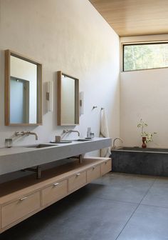 a bathroom with two sinks and a bathtub