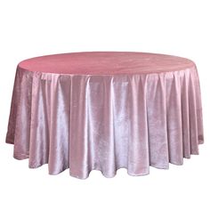 a round table covered in pink velvet