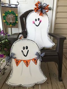 two halloween decorations sitting on top of a chair