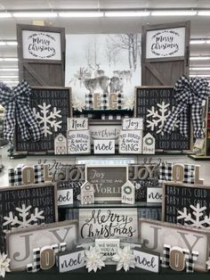 christmas decorations are displayed on shelves in a store with snowflakes and plaid bows