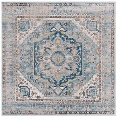 a blue and beige rug with an ornate design on the center, in front of a white background