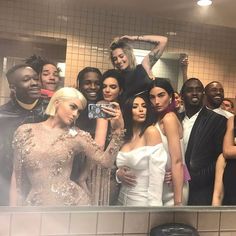 a group of people taking a selfie in a bathroom