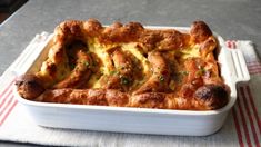 a casserole dish with meat and cheese in it on top of a table