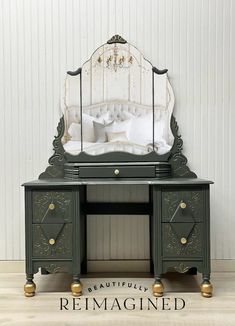 a green vanity with a mirror on top of it and a bed in the background