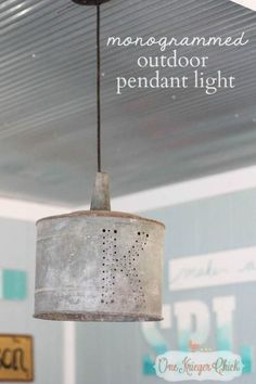 an old light hanging from the ceiling in a garage with text overlay that reads, monogrammed outdoor pendant light