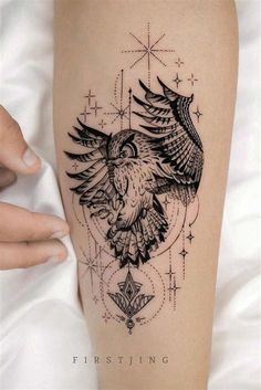 a tattoo on the leg of a woman with an owl and stars in the background