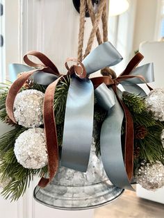 a bell decorated with pine cones, balls and ribbon for christmas or new year's eve