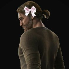 a man with a ponytail and a bow in his hair is looking down at something