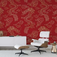 an elegant red wallpaper with gold floral designs on it and two white chairs in front