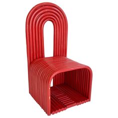 a red chair that is shaped like a stacking device with one section open and the other part closed