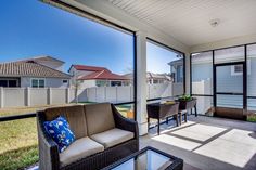 an outdoor living room with patio furniture and sliding glass doors