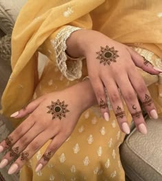 two women with henna tattoos on their hands