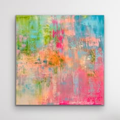 an abstract painting in pink, blue and green on a white wall with a chair