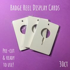 three white plastic cards with holes in them on a purple background that says badge reel display cards pre - cut & ready to use