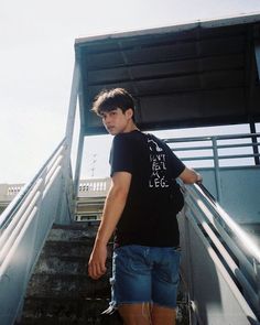 a young man is walking up some stairs