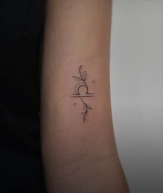 a woman's arm with a small tattoo on the left side of her arm