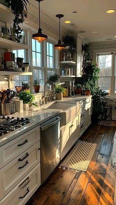 a kitchen filled with lots of white cabinets and counter top next to a stove top oven