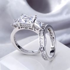 two white gold wedding rings with princess cut diamonds