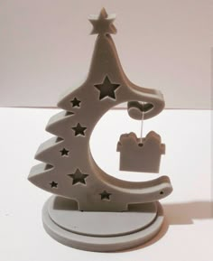 a small white christmas tree with stars on it