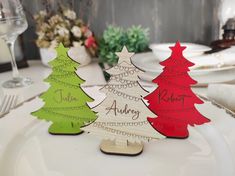 three wooden christmas trees sitting on top of a white plate