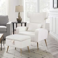 a living room with two chairs and a footstool in front of a window