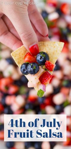 a hand holding a slice of fruit salsa with the words 4th of july fruit salsa on it