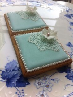 two decorated cookies sitting on top of a table