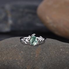 a green ring sitting on top of a rock