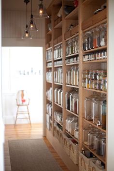 the pantry is filled with many jars and containers