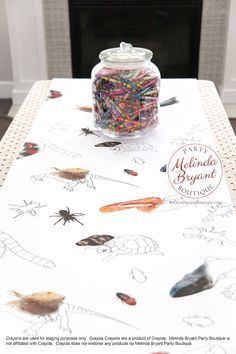 a table topped with lots of different colored beads and sprinkles next to a fire place