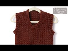 a brown knitted vest hanging on a white hanger