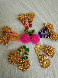 several different types of brooches arranged in a circle on a white tablecloth