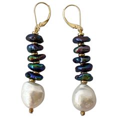 These stunning earrings feature bright iridescent Black oil spill / peacock Pearls separated by contrasting Gold plated Roundales. The bright contrast between the textured Black Pearls and Gold is perfectly balanced with a large smooth Baroque White Pearl at the end. These earrings measure 2.5 inches long and a versatile and a perfect fit for any vibrant personality. **All jewelry is handmade by designer for any custom sizing, color, material,or any other requests, please contact Marina J. Price Black Pearl Jewelry, Peacock Pearls, Black Pearls, J Black, Oil Spill, Black Oil, Stunning Earrings, Black Pearl, Baroque Pearls