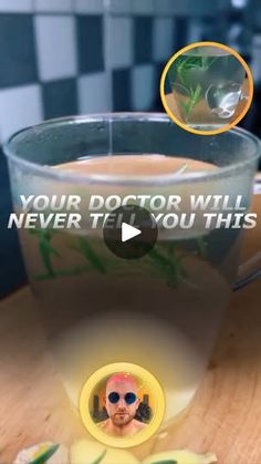 a glass cup filled with liquid sitting on top of a wooden table next to a banana