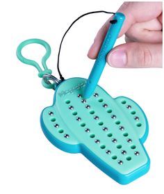 a person is holding a toothbrush shaped like a hand grater with holes in it