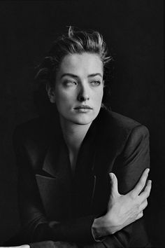 a black and white photo of a woman with her arms crossed