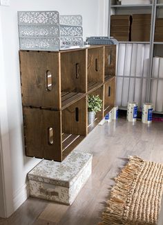 some boxes are stacked on top of each other in a room with wood floors and white walls