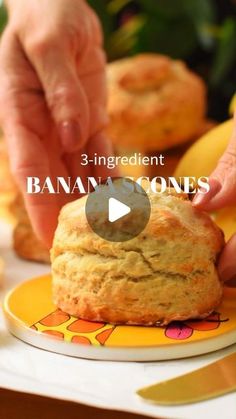 someone is placing a biscuit on top of a yellow and orange plate with the words, 3 - ingredient banana & coconut biscuits