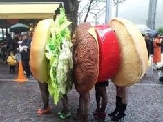 two people dressed as hamburgers standing next to each other