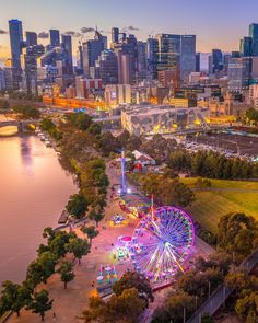 an aerial view of a ferris wheel and the city skyline